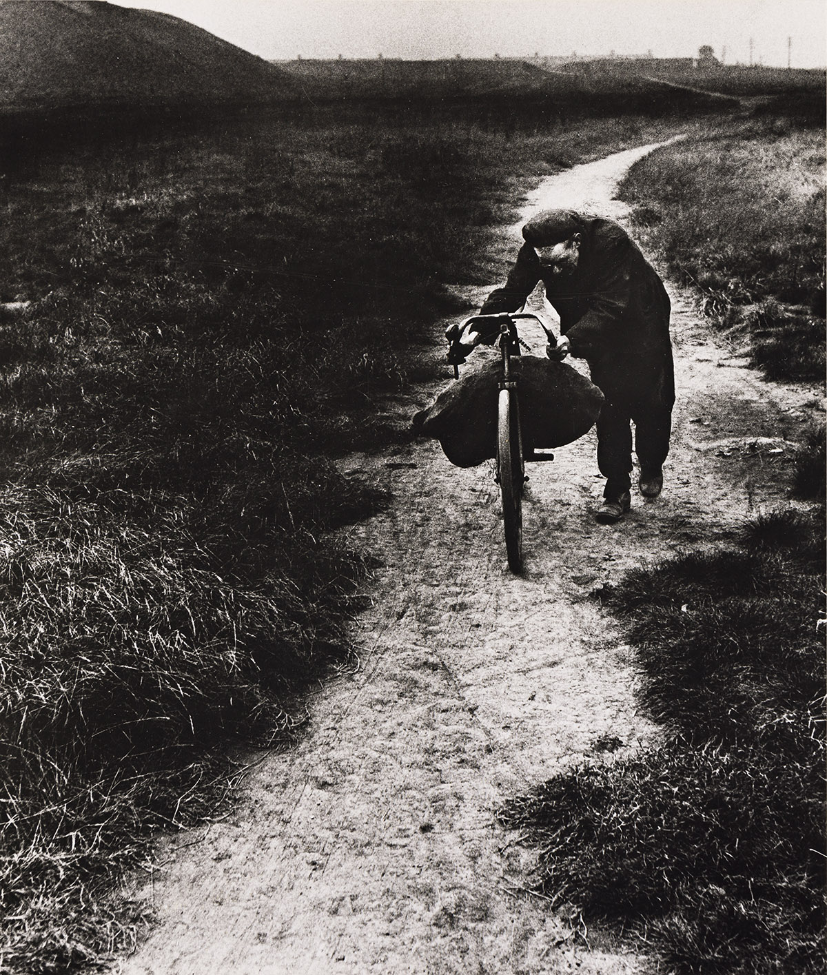 BILL BRANDT (1904-1983) Coal-Searcher Going Home to Jarrow.